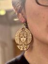 Close-up of a wooden Nefertiti earring, showing intricate Egyptian queen details. Lightweight birch plywood design perfect for African-inspired jewellery enthusiasts.